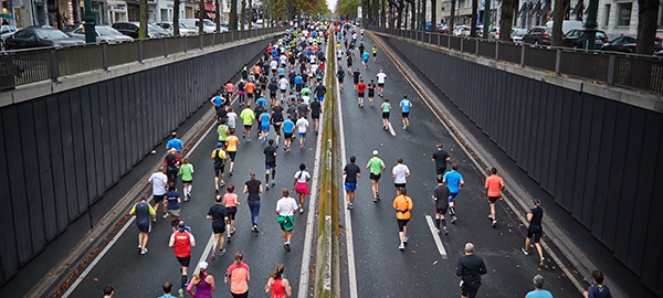 Marathon runners running along a city street